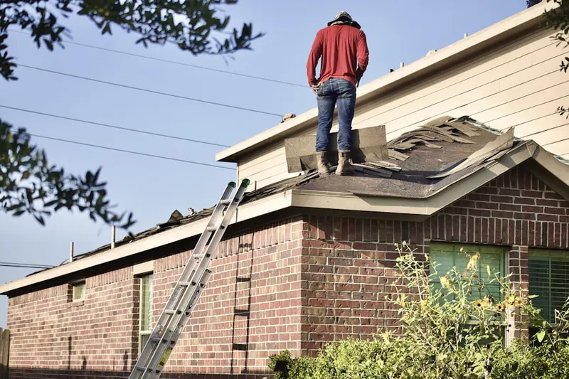 Professional roofer working on a residential roof in Sun Valley